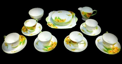 A Shelley porcelain part tea service, decorated in the John Quil daffodil pattern, comprising bread plate, cream jug, sugar bowl, six cups, saucers and tea plates. (AF)