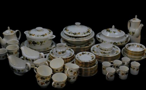 A Royal Worcester porcelain part dinner tea and coffee service, decorated in the Larchmont pattern, comprising casserole dish, further dish and cover, a pair of vegetable tureens and covers, meat platter, pair of sauce boats on stands, oval dish, nine din