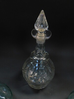 A Victorian cut glass decanter and stopper, with engraved decoration, 32cm high, together with a pair of moulded glass carafes, 27.5cm high. (3) - 2