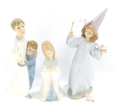 A Lladro porcelain figure modelled as Magical Moment, 06171, boxed, together with a Lladro figure group of a boy and girl in night attire, with a chamber stick, and a further Lladro figure of a kneeling girl. (3)