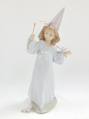 A Lladro porcelain figure modelled as Magical Moment, 06171, boxed, together with a Lladro figure group of a boy and girl in night attire, with a chamber stick, and a further Lladro figure of a kneeling girl. (3) - 5