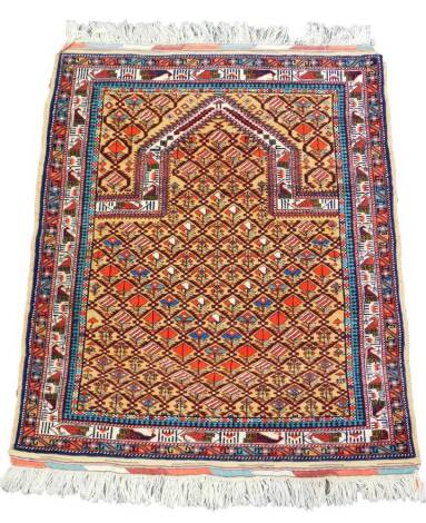 An Afghan prayer rug, the Mihab field filled with repeating floral motifs, against a light brown ground, within a border of stylised birds and geometric motifs, 139cm x 107cm.