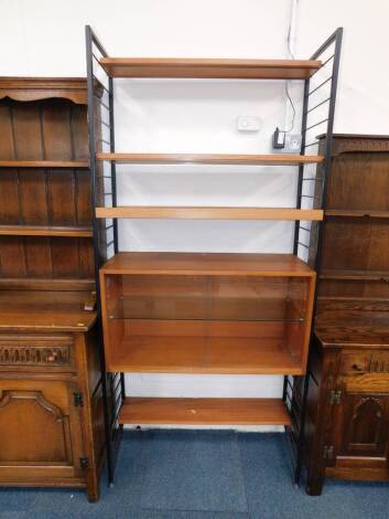 A Staples Ladderax shelving unit, with four variously sized shelves, and a two door glazed bookcase enclosing a single shelf, 200cm high, 93cm wide.