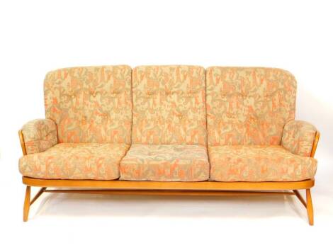 An Ercol ash studio couch, with foliate patterned cushions, 190cm wide.