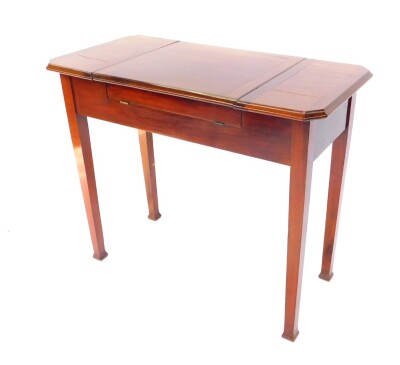 An Edwardian mahogany 'Britisher' writing table, of canted rectangular form, the central hinged section opening to reveal a fitted interior, with two hinged side flaps, raised on tapering square legs, 76cm high, 91cm wide, 44.5cm deep. - 5