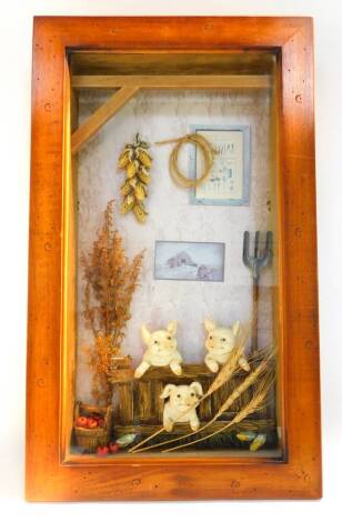 A wooden and glazed diorama 'The Three Little Pigs', 58cm high, 34cm wide.