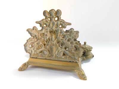 A Victorian style brass desk stand, cast with cherubs, fruit and flowers, with letter rack pen tray and pair of ink wells, 30cm wide. - 4