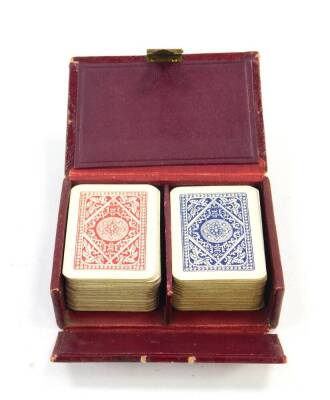 A Patience two pack playing card set, red morocco cased.