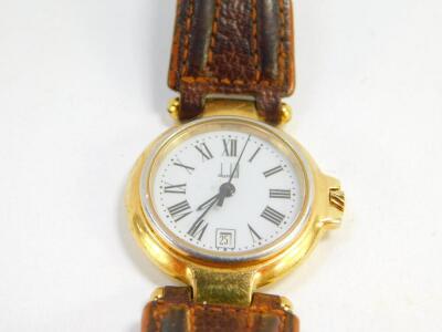 A Dunhill ladies stainless steel and gold plated wristwatch, circular white dial bearing Roman numerals, centre seconds, date aperture, quartz movement, serial number P12 20452, on a leather strap. - 2