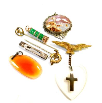 An Italian shell cameo pendant, View of the Bay of Naples with Vesuvius beyond, in a white metal filigree surround, an Air Force Commemorative brooch with an eagle, and heart and cross pendant, silver tie clip, agate pendant, two Victorian tie pins, and a