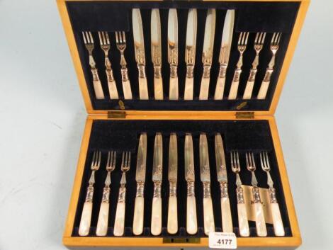 A set of twelve Edwardian silver plated dessert knives and forks