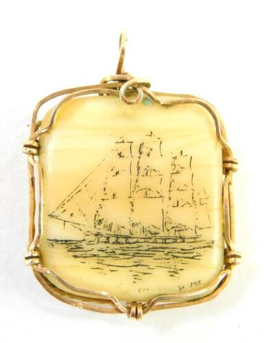 A Scrimshaw type pendant, with ship scene, in a yellow metal wire frame, unmarked.