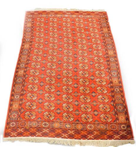 A Tekke red ground rug, decorated with seventy five guls and other geometric motifs, 313cm x 191cm.