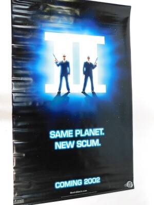 An advertising film banner Men In Black II, Same Planet New Scum, Coming 2002., 130cm x 217cm.