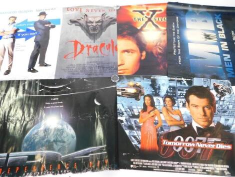 Six film posters, comprising Tomorrow Never Dies., Dracula., Independence Day., Catch Me If You Can., The X-Files, and Men In Black.