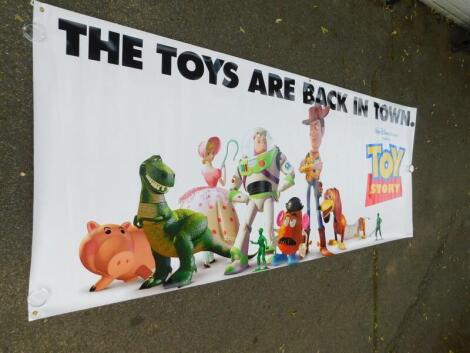 An advertising film banner Toy Story, The Toys Are Back In Town, 120cm x 307cm.