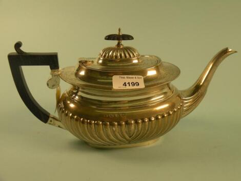 A part fluted silver teapot with ebonised handle and knop