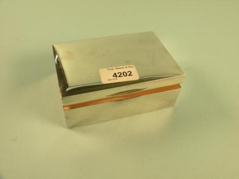 A rectangular silver cigarette box and cover