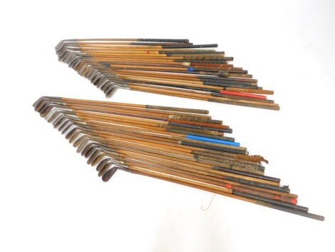 A collection of vintage golf clubs, all irons and wedges with wooden shafts. (41)