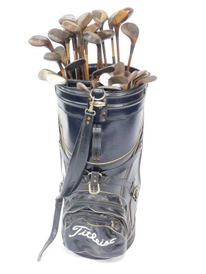 A large Titleist golf or display bag, containing a collection of vintage drivers, mainly wooden shafted, and a selection of wedges and irons, all wooden shafted. (39) - 2