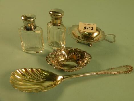 A silver spoon with a shell shaped bowl