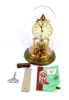 A Schatz brass four hundred day anniversary clock, circular cream dial bearing Arabic numerals, single barrel movement, under a glass dome, with instructions, 31cm high.