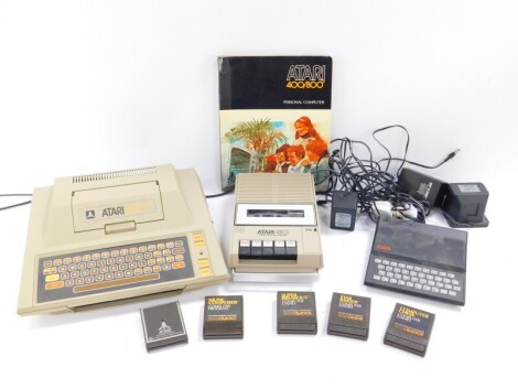 An Atari 400 personal computer, 410 programme recorder, computer games and an operator's manual, together with a Sinclair ZX81 personal computer.