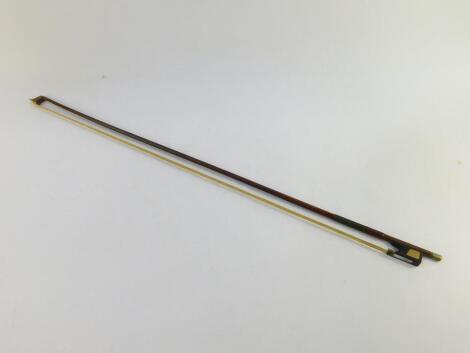 A violin bow, signed indistinctly, 73.5cm wide.