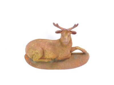 A cast iron door stop, cast as a recumbent buck deer, 22cm high, 37cm wide.