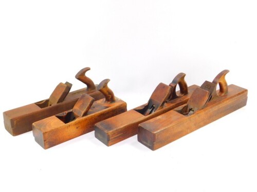 Four beech block planes, 55.5cm (2), 47cm and 43cm respectively.