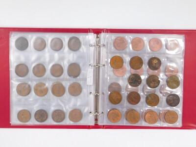 A coin album containing a collection of pre-decimal British coins.