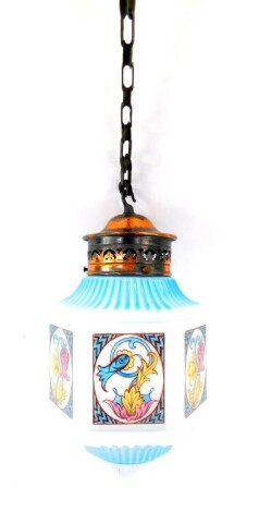 A 1920's frosted and coloured glass hanging pendant lantern light, of hexagonal form, with panels of stylised flowers and foliage, in blue, pink and ochre, and with pierced copper fitting and pendant attachment, 31cm high.