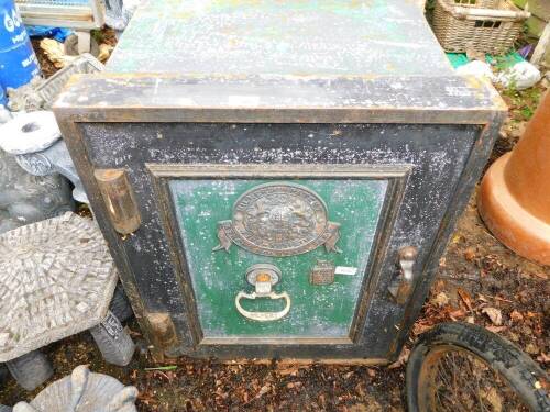 A Milner's strong hold fast metal safe, in green and black, with Milner's central crest, with key, 71cm high, 57cm wide, 56cm deep.