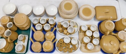 A Denby pottery dinner tea and coffee service decorated in the Ode pattern, comprising casserole dish and cover, pie dish and cover, and a pair of vegetable tureens and covers, rectangular meat platter, eight dinner, dessert and side plates, eight fruit