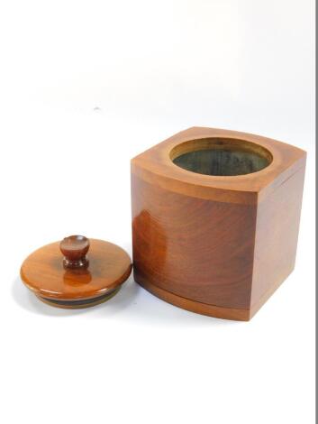 An Art Deco walnut bow fronted square tea caddy, with a cylindrical lid, 12.5cm high.