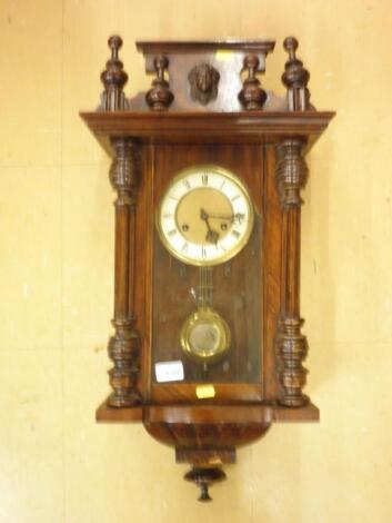 A late 19thC Vienna wall clock in a walnut case