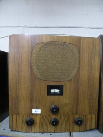 A 1930s walnut radio with bakelite fittings