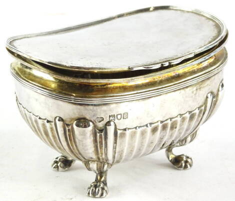 An Edward VII silver boat shaped sugar box, the hinged lid enclosing a vacant interior, the base with part fluted body, on paw feet, London 1901, by The Goldsmith & Silversmith Company, 11oz, 13cm wide.