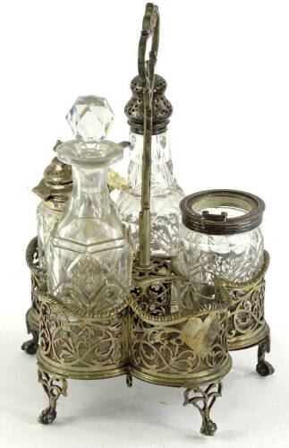 A Victorian five division cruet stand, with a pierced handle and sides, on shaped legs with ball and claw feet, London 1853 and four bottles, some with silver mounts (AF), the stand 17¼oz.