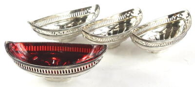 A set of four late 18th/early 19thC silver boat shaped dishes, each with a pierced edge and sunburst to the base, one red glass liner, lacking date letter, makers stamp TP, possibly for Thomas Pitts, 16oz.