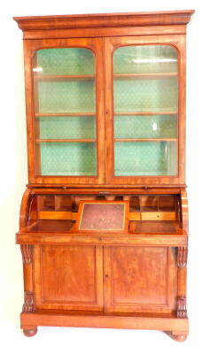 A Victorian mahogany cylinder bureau bookcase, the top with a moulded cornice with two glazed doors, enclosing adjustable shelves, the base with a fall enclosing a satinwood veneered interior with adjustable writing slope, above two panel doors flanked by - 2