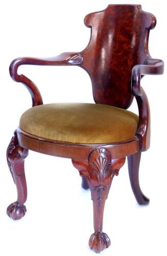 A 19thC mahogany open armchair in the manner of Gillows, the figured shaped back joined by shepherd's crook arms, with an oval drop in seat, on cabriole legs, headed by shells, on ball and claw feet. Provenance: by repute from Normanby Hall