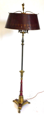 A continental gilt brass and red coloured standard lamp, the concave platform base with paw feet, the column of tapering form, applied with shell and scroll etc., 170cm high.