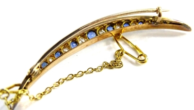 A sapphire and diamond set crescent brooch, with various old cut sapphire and diamonds, in claw setting, on single pin back, with safety chain, yellow metal, unmarked, 5.5cm wide, 3.6g all in. - 2