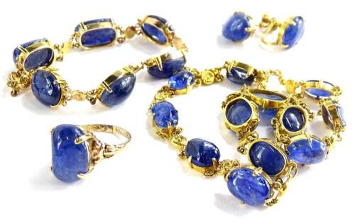 Withdrawn presale by vendor- A 9ct gold polished sapphire set jewellery set, comprising ring, pair of earrings, bracelet and a necklace, the ring with natural uncut stone in four claw setting, with fan design shoulders, ring size O, a pair of screw back e