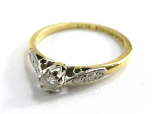 An 18ct gold and platinum diamond solitaire ring, with single round brilliant cut diamonds, approx. 0.15cts, with platinum splayed shoulders, on a yellow metal band, ring size J, 1.9g all in.