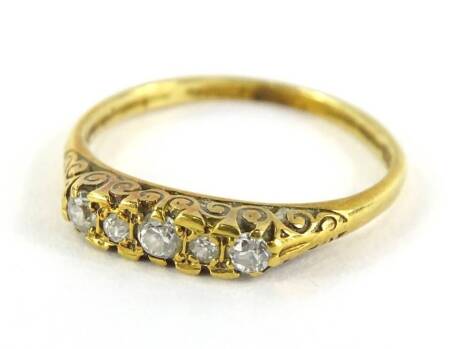 An 18ct gold diamond set gypsy ring, set with five old cut diamonds, each in claw setting, with scroll design shoulders and ring head, ring size Q½, 2.7g all in.