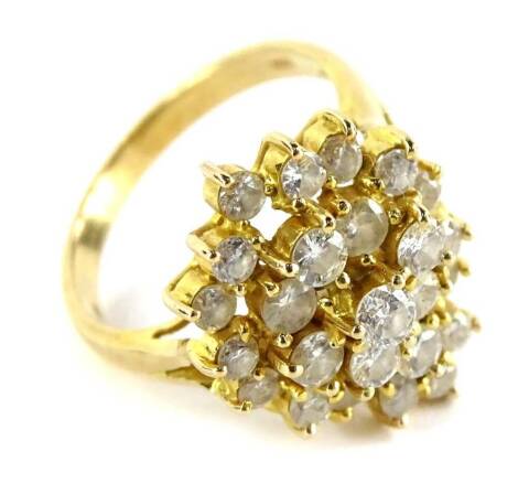 A diamond set cluster ring, with tear drop type design round brilliant cut diamonds, in a layered three claw setting, with three rows, with V splayed shoulders, and a yellow metal band stamped 14K, ring size P, 5.5g all in (some replacement stones).