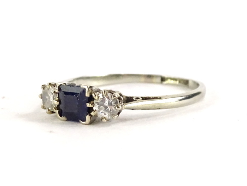 A Victorian 18ct white gold and platinum diamond and sapphire ring, set with square cut sapphire, flanked by two round brilliant cut diamonds, in claw setting, ring size N, 2.4g all in, boxed.