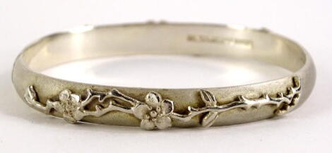 A silver cuff bracelet, marked 2005 Tiffany & Co, 925, with raised floral design, 6cm diameter, 28.9g all in.